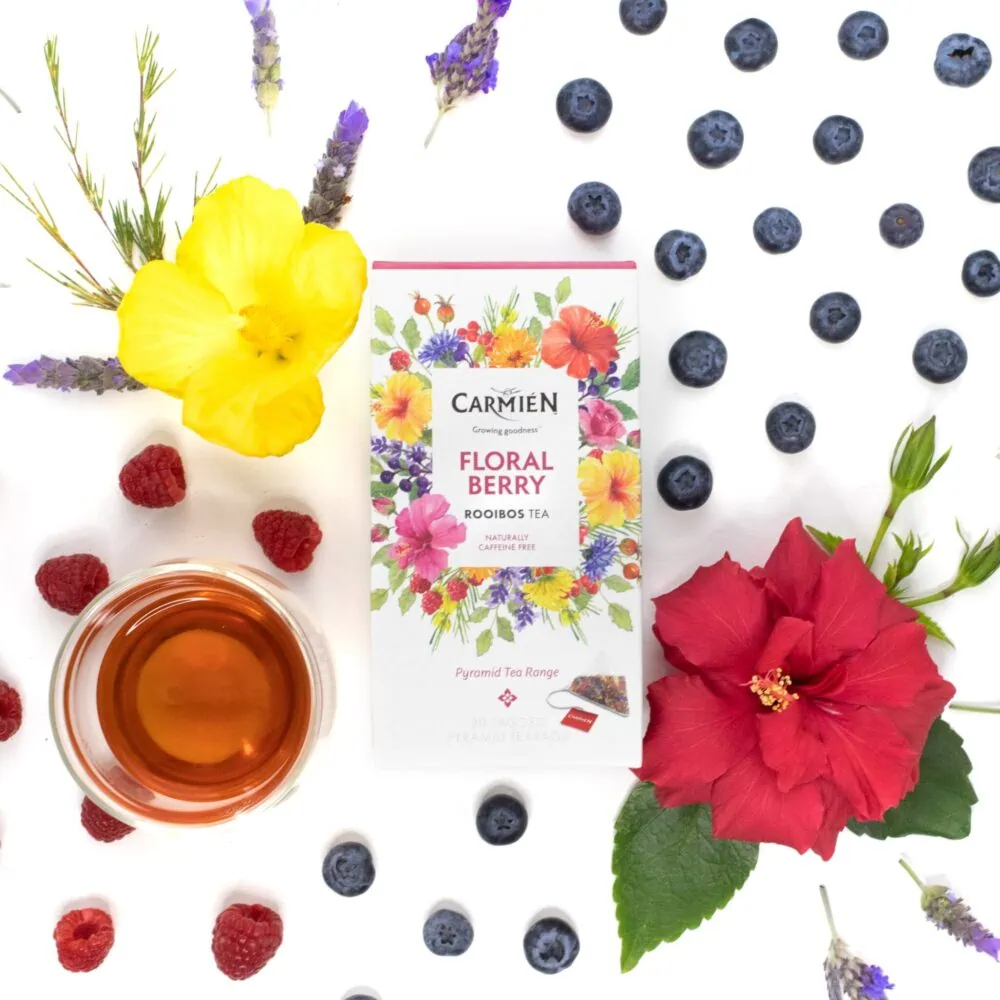 Carmién Floral Berry Rooibos Tea with fresh berries and flowers for a vibrant, fruity tea experience.