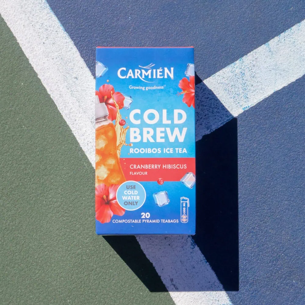 Carmién Cranberry Hibiscus Cold Brew Rooibos Tea box on a colorful background, highlighting the tea's refreshing and natural qualities for e-commerce sales.