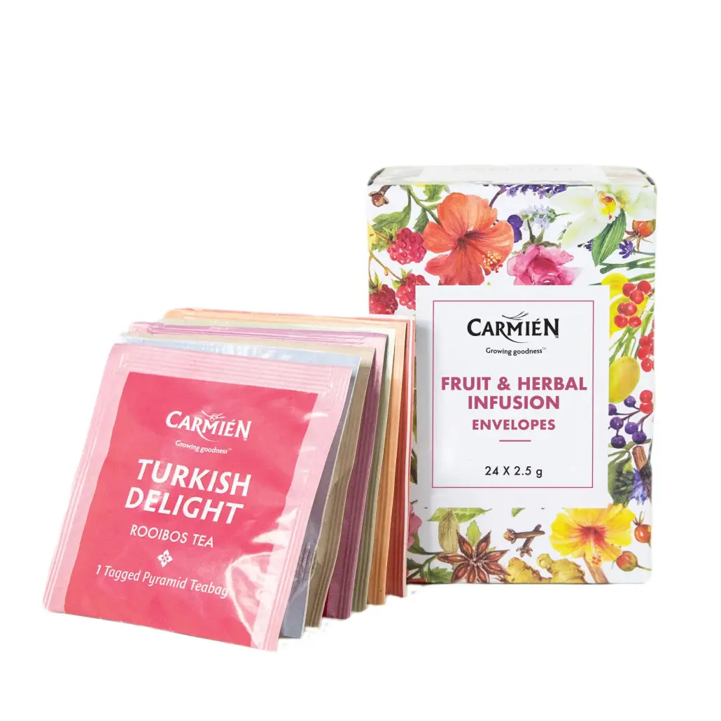 Assorted Carmién Tea fruit and herbal infusion envelopes with floral design packaging and colourful tea bag wrappers, showcasing premium rooibos, herbal, and fruit teas from South Africa.