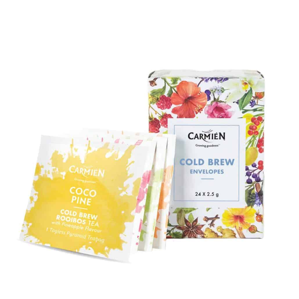 Vibrant herbal tea packaging featuring Carmién Cold Brew Envelopes and Coco Pine Rooibos Tea, showcasing natural botanicals and bright, colorful floral designs for a healthy, refreshing beverage experience.