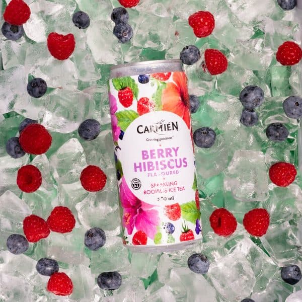 Refreshing berry hibiscus flavored Rooibos ice tea can with vibrant, fruity packaging surrounded by ice and fresh berries for a cool, antioxidant-rich beverage experience.