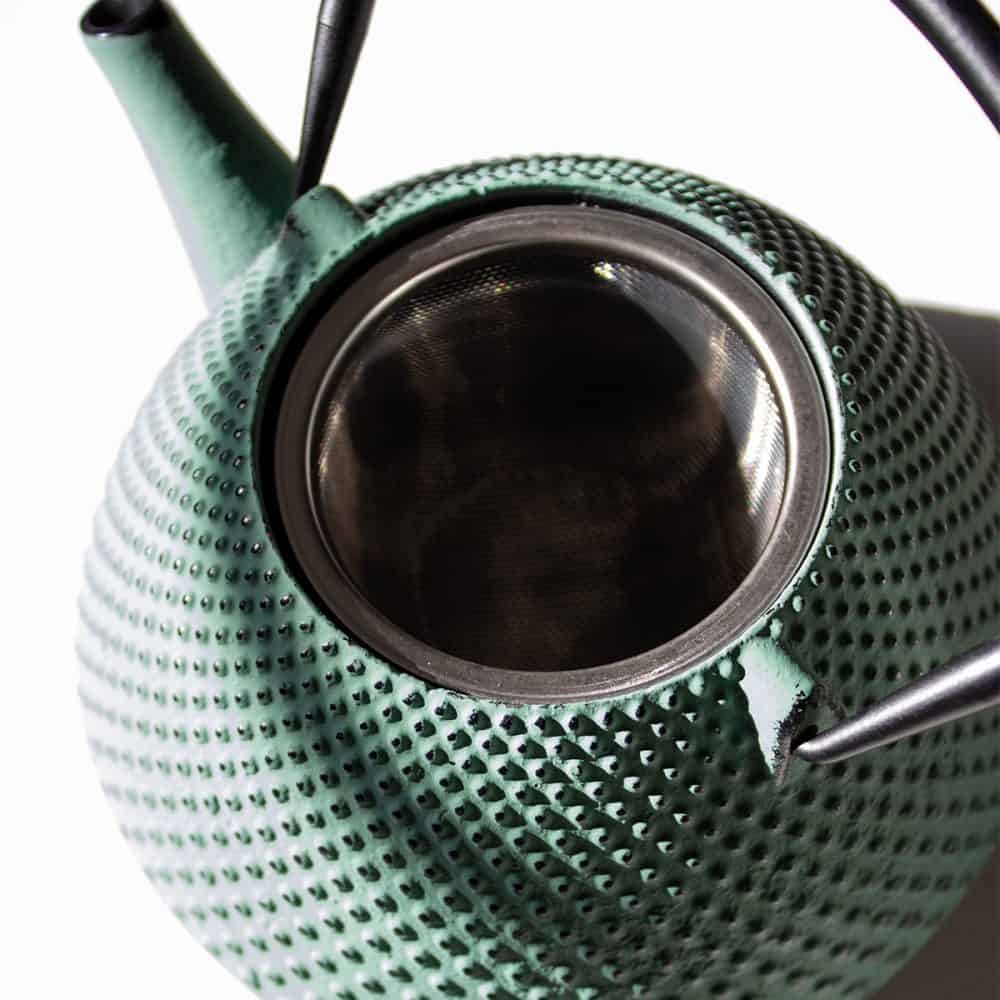 Elegant sage green cast iron teapot with a pear-shaped design, perfect for brewing and serving tea. Durable and heat-retentive, ideal for tea enthusiasts seeking quality and style.
