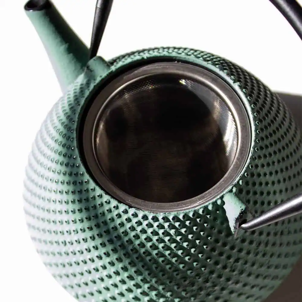 Elegant sage green cast iron teapot with a pear-shaped design, perfect for brewing and serving tea. Durable and heat-retentive, ideal for tea enthusiasts seeking quality and style.