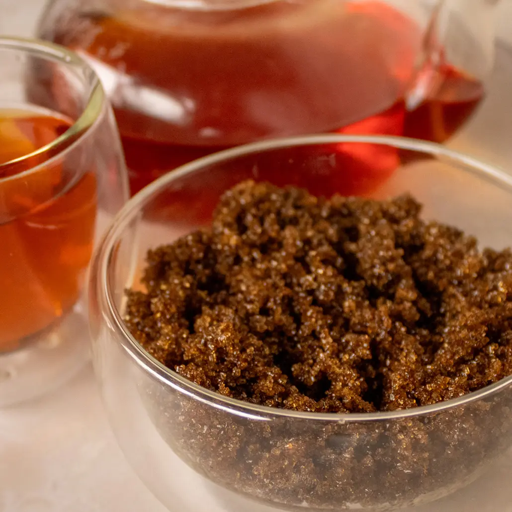 Rich Rooibos and Honeybush tea leaves with brewed herbal tea in glass cups from Carmién Tea.