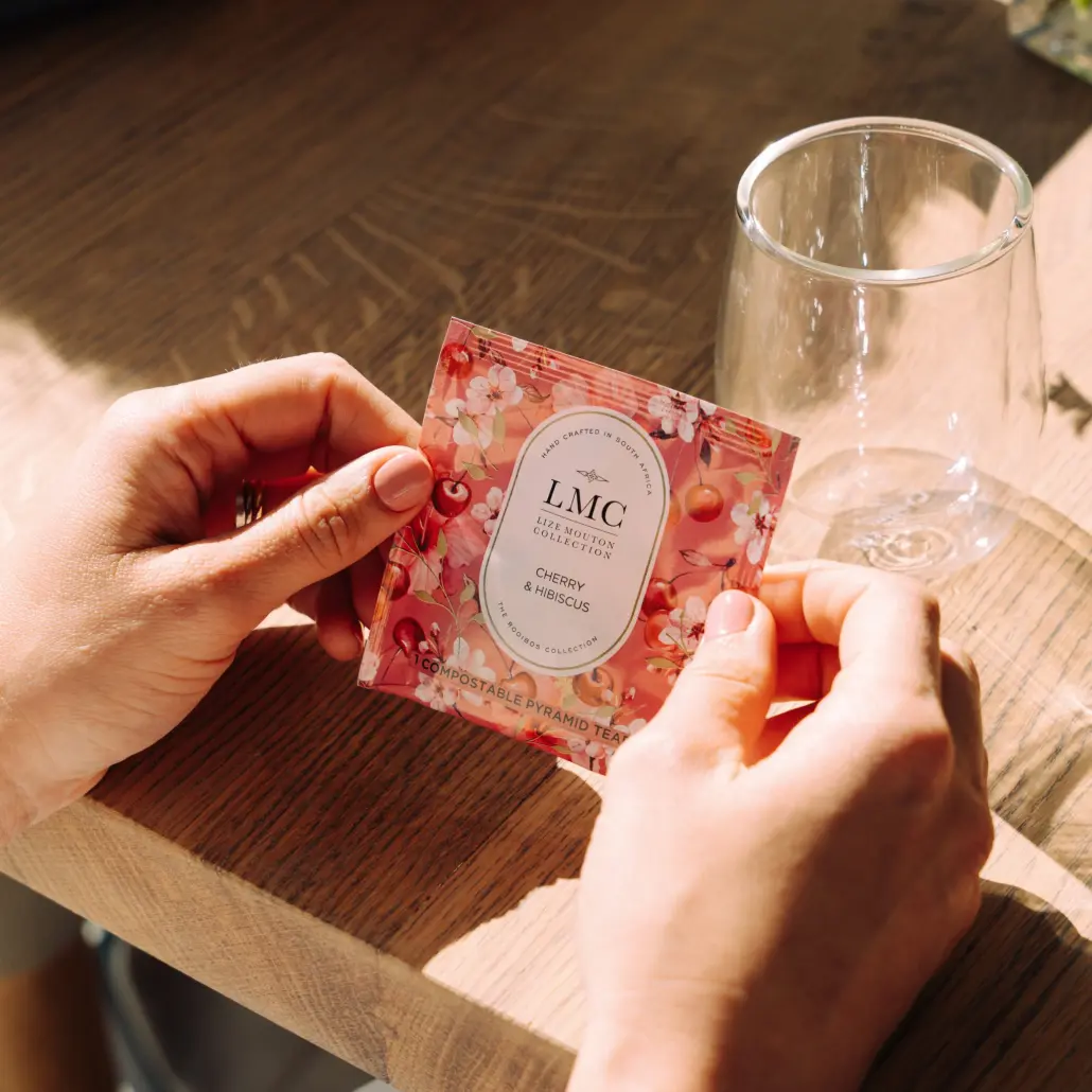 Elegant, eco-friendly Carmién Tea packaging with cherry and hibiscus flavor, perfect for healthy tea lovers and sustainable living — ideal for South African herbal tea enthusiasts.