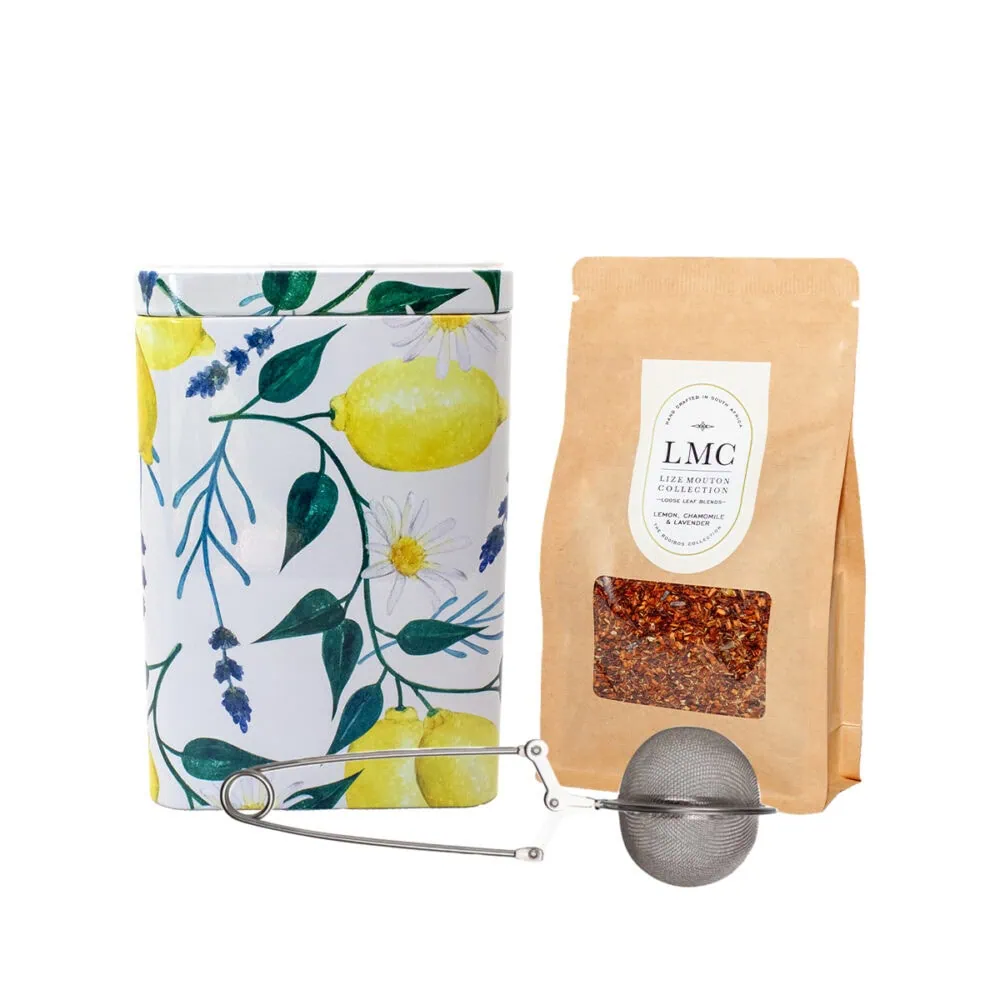 Brightly decorated tea canister with lemon and lavender illustrations, accompanied by a tea infuser and a package of loose leaf tea from Carmién Tea, emphasizing natural ingredients and artisanal qual.