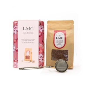 Relaxing herbal tea set with loose leaf tea and strainer, part of the Carmién Tea LMC collection, featuring cherry and hibiscus rooibos for wellness and natural flavor.