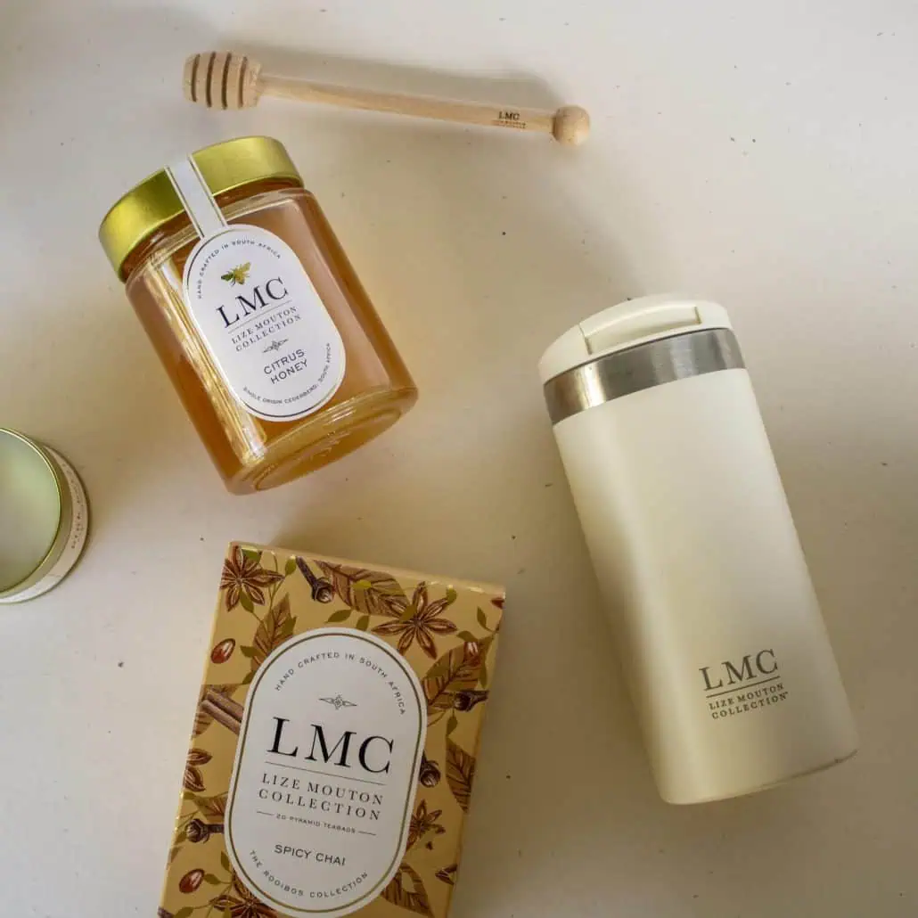 Aromatic Carmién Tea products including honey, tea, and a thermos on a white surface, highlighting natural South African herbal tea gifts and collection.