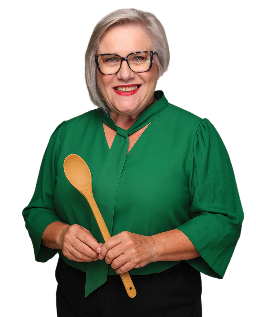 Rooibos tea expert Carmen Niehaus holding a wooden spoon, showcasing the versatility of Carmién Rooibos in cooking and tea preparation.