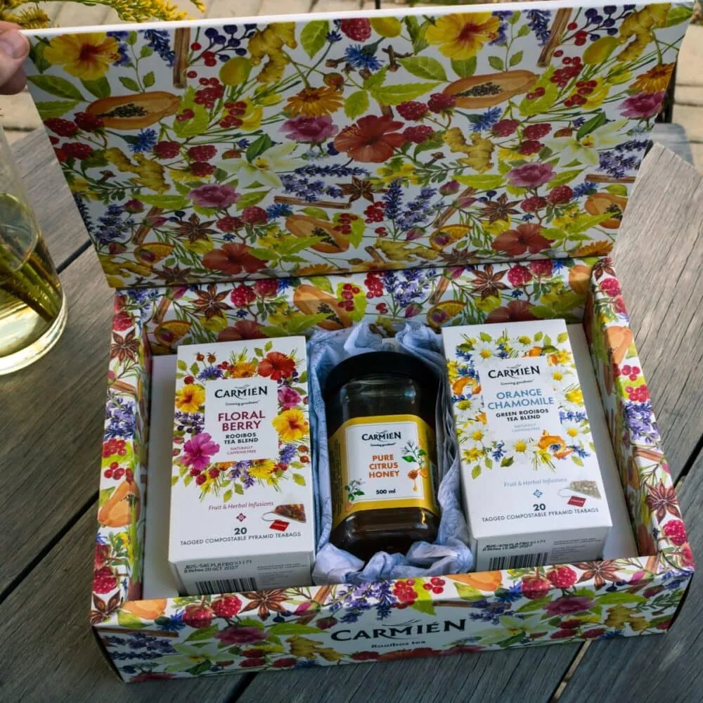 Elegant pyramid tea gift box with citrus honey and floral berry teas.