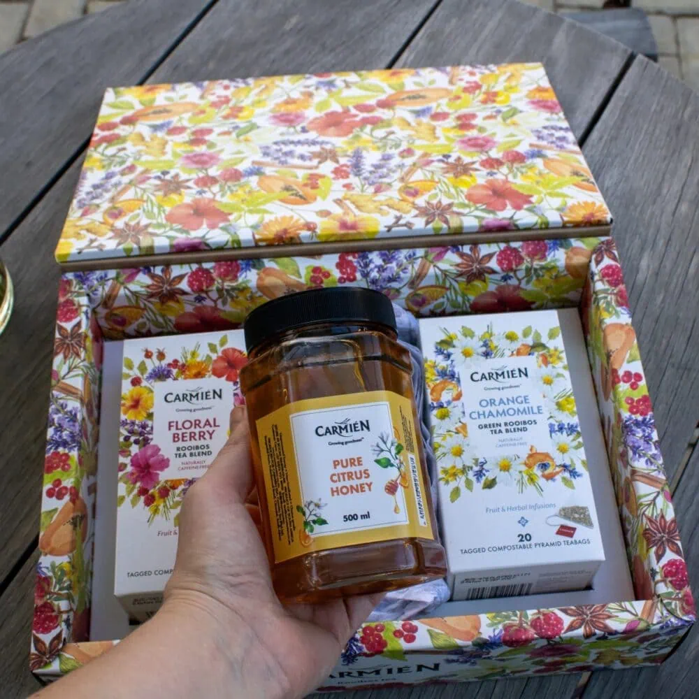 Gift box with Orange Chamomile tea, Floral Berry pyramid teabags, and pure citrus honey for a soothing tea experience.