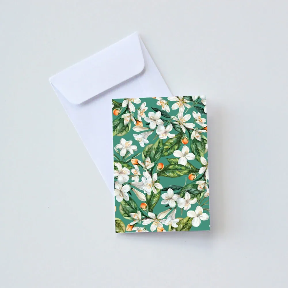 Elegant Carmién Tea gift box featuring 3 x 20 teabags, perfect for gifting. Beautiful floral design with white blossoms and green leaves, showcasing premium South African herbal tea.