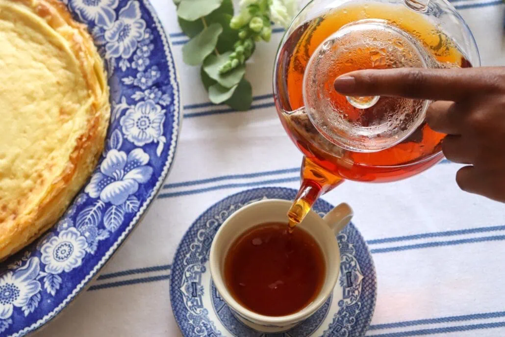 Rich Rooibos tea served in a glass teapot and cup, highlighting the natural infusion process.